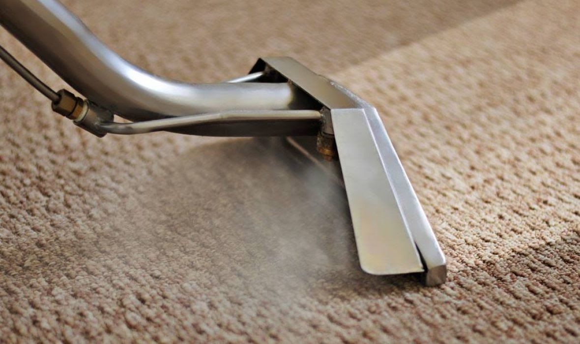Hot water extraction wand cleaning a carpet